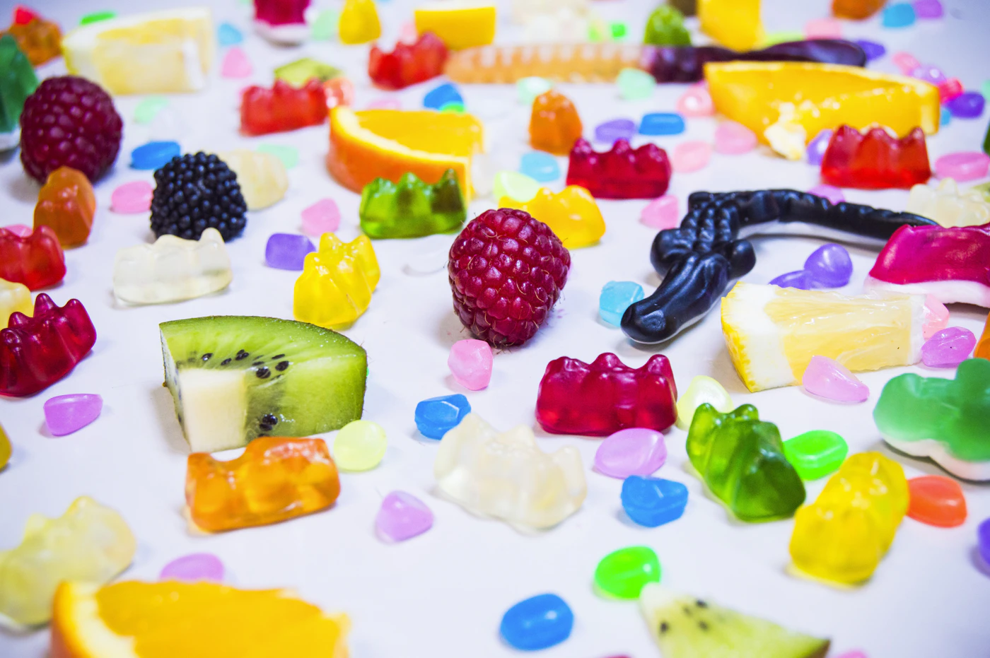 Colorful gummy bears, berries and fruit-shaped candies